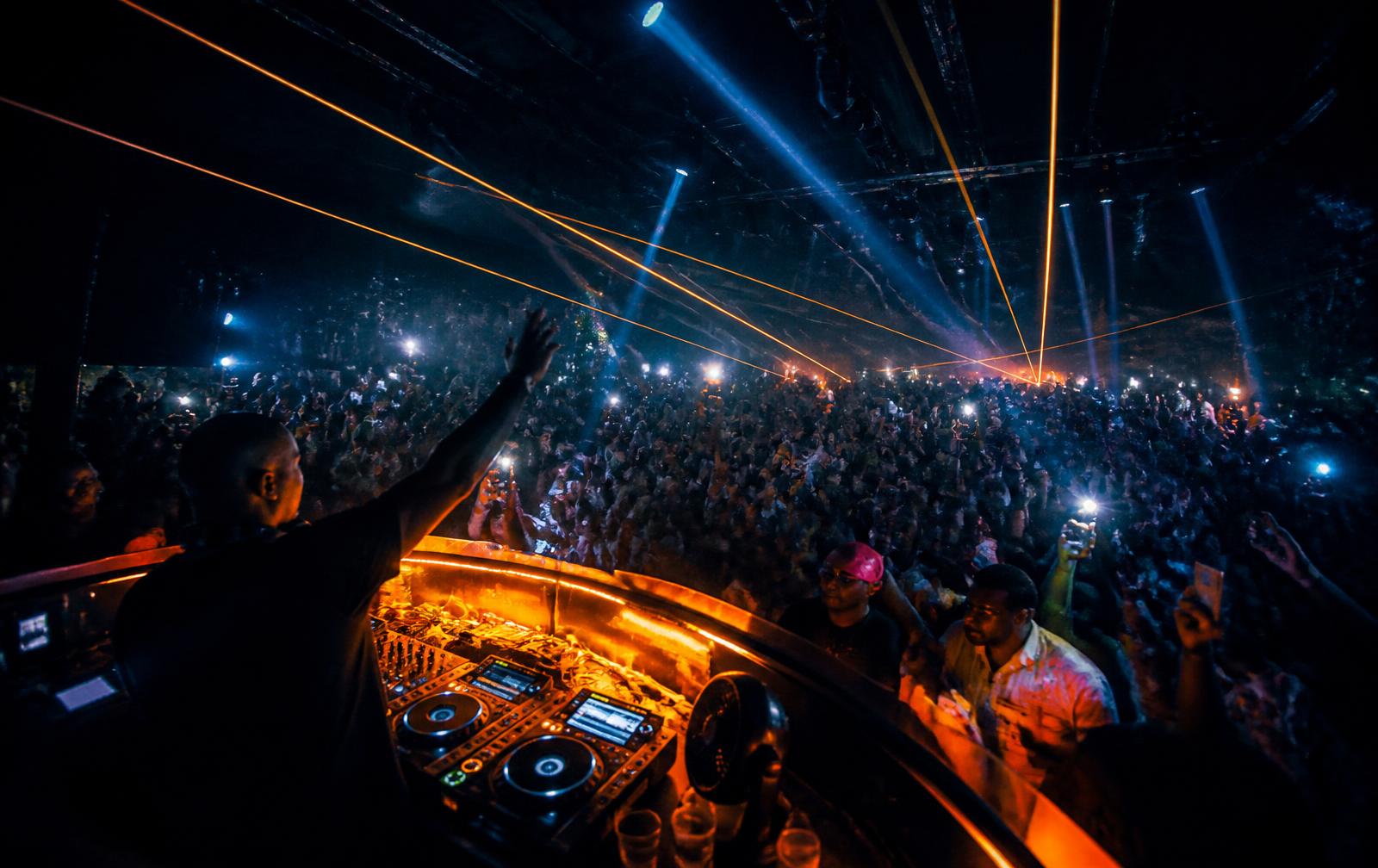 A packed Friday night crowd at a Lagos club with amber lights